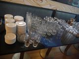a lot of glasses and plates on the table