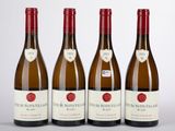 trois bouteilles de vin sont alignées sur une surface blanche
