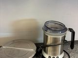 a blender sitting on the counter next to a coffee pot
