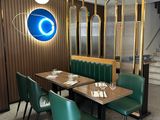 a dining room with green chairs and a wooden table
