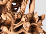 a wooden sculpture of a group of people riding on horses