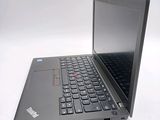 a laptop with a black keyboard on a white surface