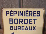 a blue and white sign on a window sill