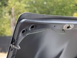 a close up of a car ' s hood with the door open