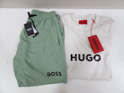 two shirts and pants are sitting on a table with a price tag