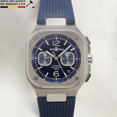 a close up of a watch on a white surface