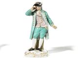 pair of figurines of a gentleman and a woman on a pedestal