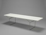an image of a white bench sitting on top of a gray floor