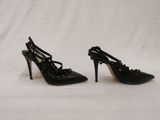 pair of black high heeled shoes on a white background