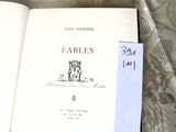 a book that is open on a bed with a tag on it