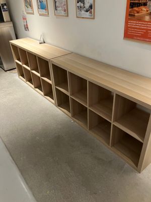 a wooden shelf with several shelves on it in a room