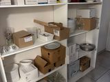 many boxes and containers on the shelves in the room