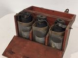 une caisse en bois contenant six bouteilles, posée sur une table