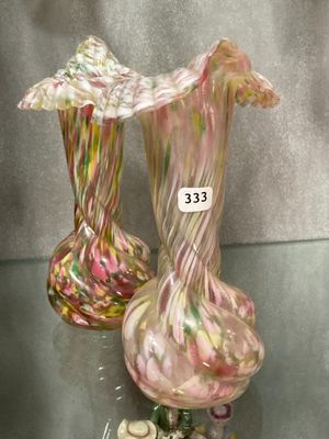two vases that are sitting on a glass table