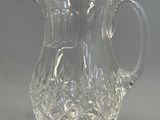 a glass pitcher that is sitting on a table