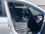 the interior of a car with the door open and the driver ' s seat down