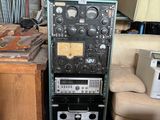 an image of a room with a lot of electronics and a couch