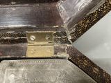 a silver plate in a wooden box on a table