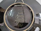a close up of a black plate with a gold rim