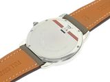 a close up of a watch on a white surface