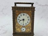 a small clock that is sitting on a marble table