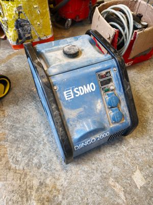 a blue and black generator sitting on the floor