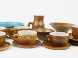 many cups and saucers sitting on a table