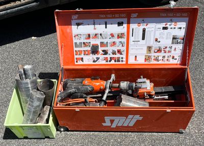 a tool box with tools in it sitting on the ground