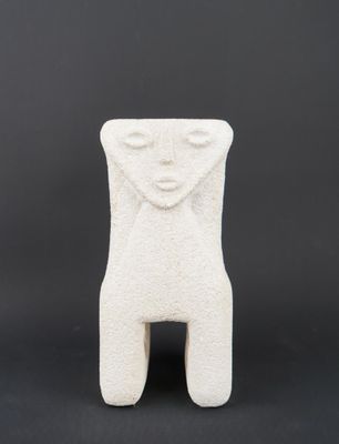 a white ceramic sculpture of a woman ' s face on a black background