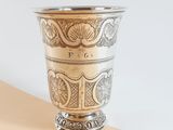 a silver cup sitting on top of a table
