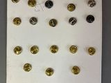 a picture of a white board with gold and silver buttons