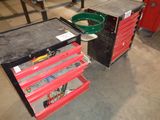 two red drawers with tools on them in a garage
