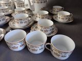 a lot of cups and saucers on the table