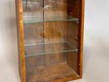 wooden display case with glass shelves on a white background