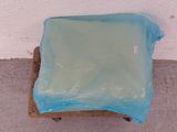 a blue plastic bag sitting on top of a wooden chair