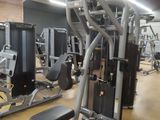 a gym room with a variety of machines in it