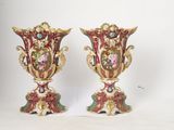 two vases are sitting on a white surface with a white background