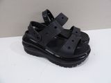 black sandals on a white table with a white wall in the background