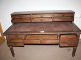 a wooden desk with two drawers on top of it