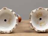 two cups that are sitting on a table