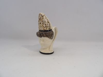 a figurine of a head with a crown on top of it