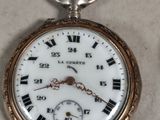 a close up of a pocket watch with roman numerals on it
