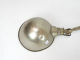 a silver lamp that is on a white table