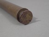 a metal pipe with holes on it sitting on a table