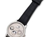 a close up of a watch on a white surface with a black strap
