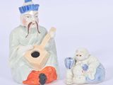 a figurine of a man playing a guitar next to a sheep