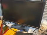a computer monitor sitting on a desk with legos on it