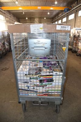 a large metal cage filled with magazines in a warehouse
