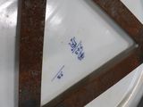 a white plate with a brown handle on a table