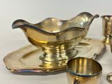 a lot of silver items that are sitting on a table